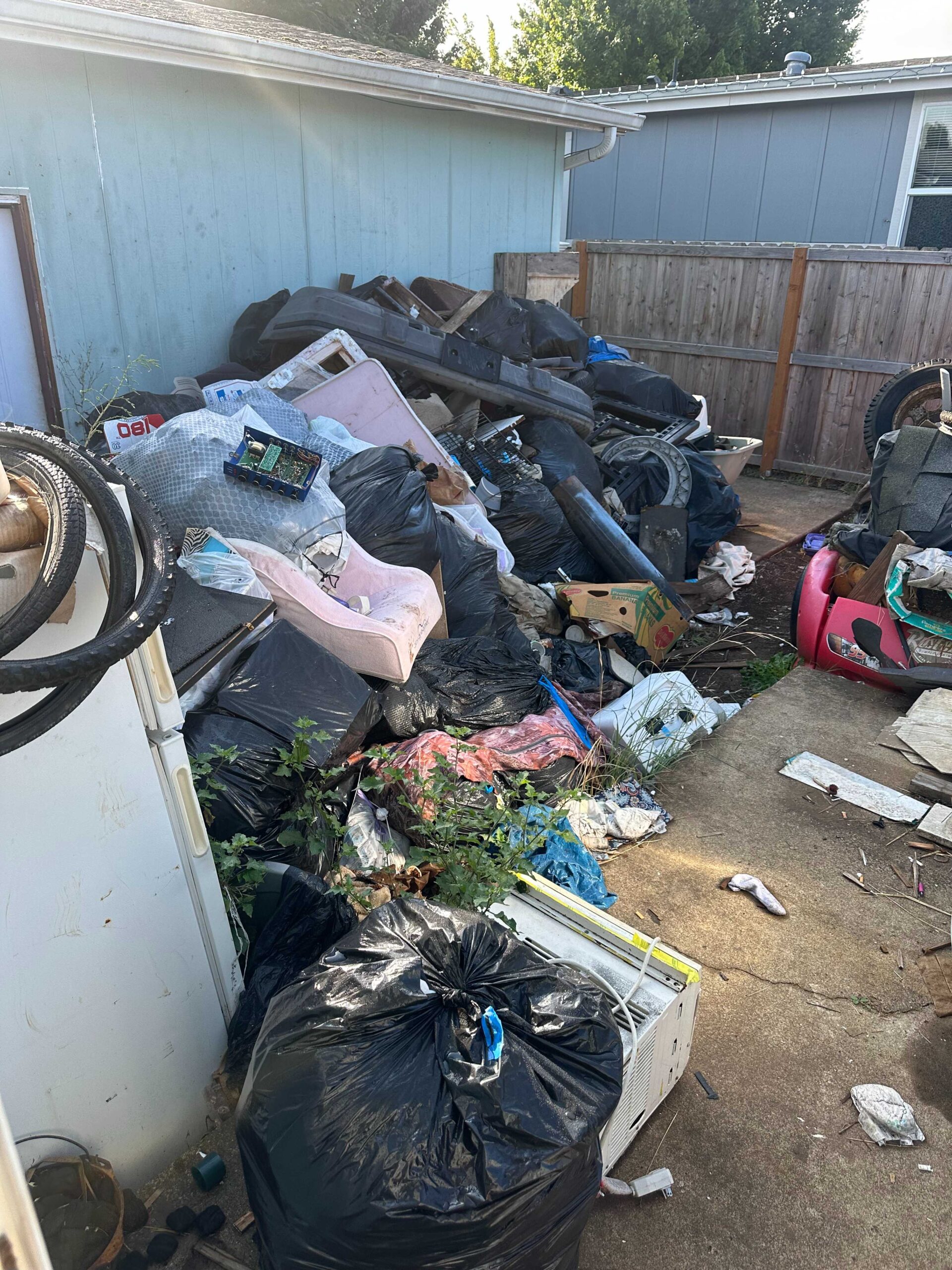 Garage cleanout Salem Oregon debris pile hauled by EZ Junk crew